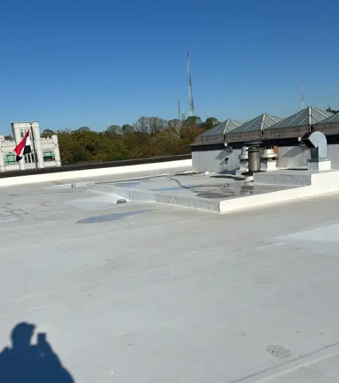 White single-ply roof with skylights and rooftop equipment on an embassy building in Washington, DC