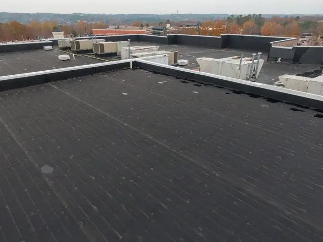 New black single-ply EPDM roof on a commercial building