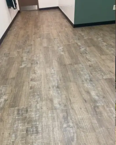 New luxury vinyl tile flooring and cove base in a school hallway