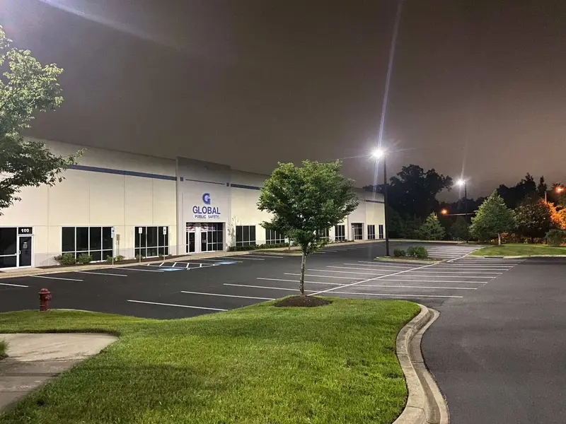 Freshly sealcoated and striped warehouse parking lot lit at night